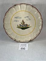 Full view of majolica plate showing scalloped rim and central landscape