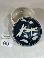 Lidded porcelain box showing lid design and interior