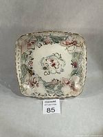 Front view of square floral slipware dish