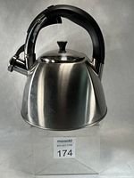 Front angled view of stainless steel kettle with black handle and spout lever