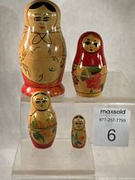 Front view of all four complete nesting dolls