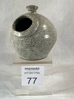 Front view showing scoop opening, knob, glaze texture, repair visible