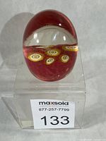 Front angled view showing egg shape, red ground and millefiori canes