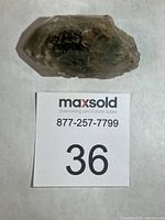 Full view of the quartz crystal beside lot card