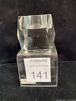 Front view of clear crystal votive showing cube shape and faceted sides