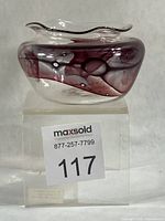 Front view of clear glass vase with cranberry swirl pattern and ruffled rim