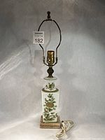 Full view of porcelain vase lamp showing hardware and cord