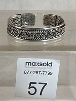 Full view of sterling silver cuff bracelet standing upright