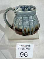 Side view of mug showing glaze patterns and body shape