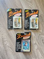 Three sealed Topps Oakland Athletics team set blister packs, two marked 1989 and one marked 1990