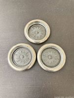 three matching Leonard silver-plated glass coasters