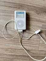 Front view of powered-on Apple iPod with cable attached