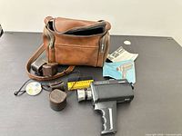 Full kit laid out: camera, bag, cases, accessories, manuals