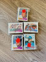 Five shrink-wrapped packets of Topps baseball cards laid out; front cards visible