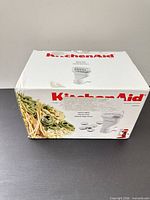 Factory box showing KitchenAid Pasta Press attachment and accessories