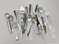 Group shot of all assorted utensils and flatware spread on tabletop