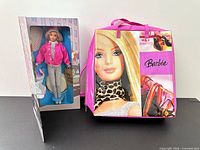 Bloomingdale’s Barbie doll in box beside pink Barbie tote bag