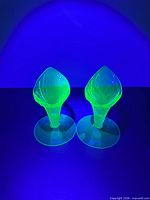 Pair of vases glowing under UV light
