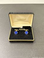 Opened Nordstrom box showing pair of gold-tone cufflinks with blue octagonal faces