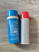 Both Thermos bottles standing upright on floor