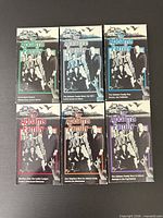 Six VHS slipcases front view showing titles and colour coding