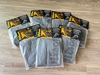 Front view of all seven sealed Wilson tote bags