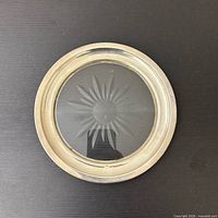Top view of coaster showing sterling rim and starburst cut glass