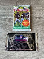 Front view of both sealed football card packs