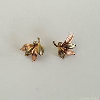 Front view of both leaf earrings showing dual-tone gold detailing