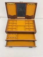 Box open showing interior mirror, hooks, lift-out tray and drawers