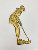 Front view of brass woman golfer plaque