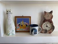 Group shot showing all four cat-themed items on shelf