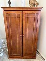 Full view of walnut media cabinet front with doors closed