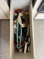 Top view of entire drawer showing variety of utensils