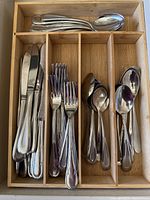 Flatware pieces sorted in bamboo organizer tray