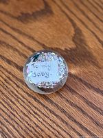 Top view of paperweight showing glitter and note