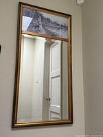 Full view of framed mirror hanging on wall
