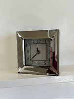 Front view of mirrored square mantel clock