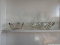 All three clear glass dessert bowls on shelf