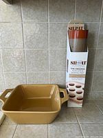 Silpat boxed mat alongside tan square ceramic dish