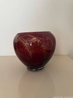 Front view of burgundy studio pottery vase with gold drip design