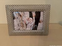 Front view of silver crystal lattice picture frame displaying 4x6 insert