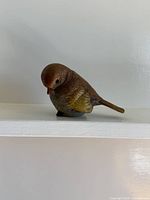 front left view of painted bird figurine