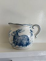 Profile showing rabbit motif and handle