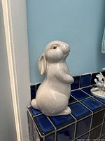 Front left view of ceramic rabbit figurine
