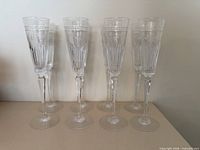 Front view of all eight crystal flutes standing in two rows