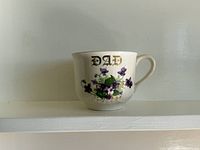 Front view showing gilt “DAD” text and floral design