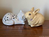 both figurines together on wood surface