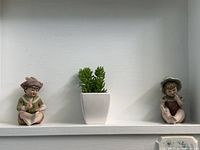 Both figurines displayed on shelf for scale and comparison