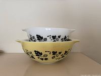 Stacked white and yellow Gooseberry bowls showing exterior patterns and size difference